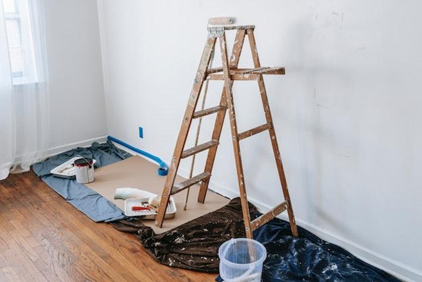 a ladder and a room being painted